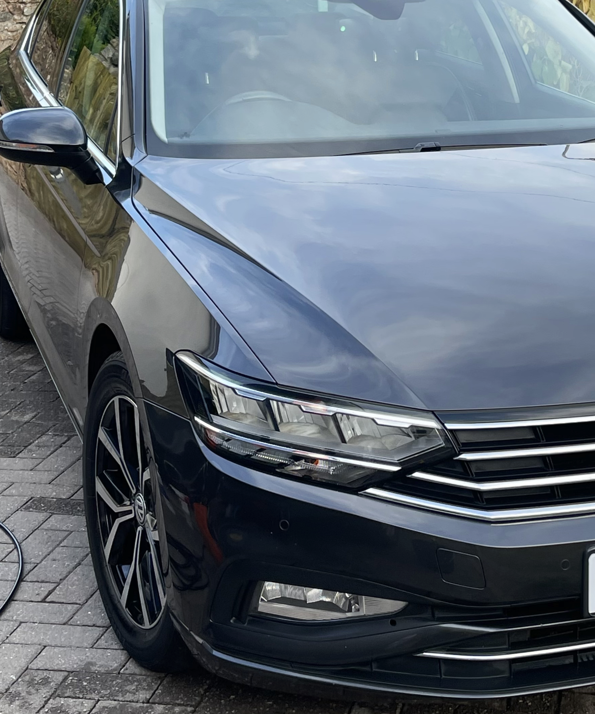 After — glossy bonnet with strong reflections, water beading